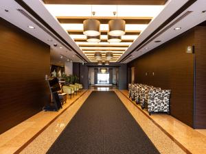 a corridor of a salon with chairs and tables at APA Hotel Yamagata Tsuruoka Ekimae in Tsuruoka +66 photos