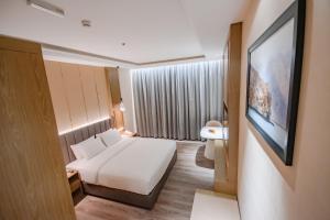 Postel nebo postele na pokoji v ubytování Frankincense Hotel Muscat فندق اللبان مسقط