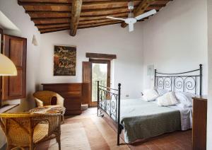 a bedroom with a bed and a ceiling fan at Private Chianti Hill Residence in Vagliagli +46 photos