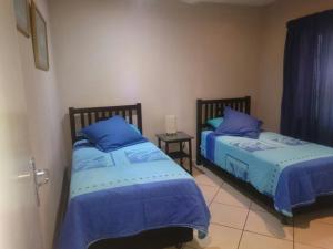 two beds sitting next to each other in a bedroom at Sea Breeze West in Margate