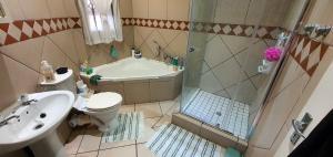 a bathroom with a shower and a toilet and a sink at Sea Breeze West in Margate +6 photos