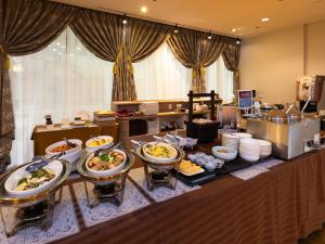 a buffet line with many different types of food at APA Hotel Yamagata Tsuruoka Ekimae in Tsuruoka