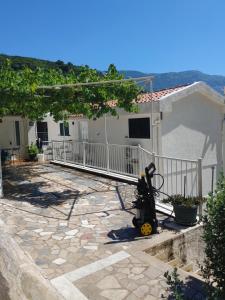 a scooter parked on a patio in front of a house at Vila Sipovac in Budva