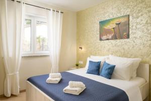 a bedroom with a bed with towels on it at Villa Putina by IstriaLux in Svetvinčenat +32 photos