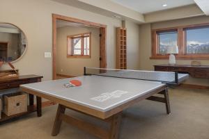 a ping pong table in the middle of a room at Stagecoach Cabin home in Fraser