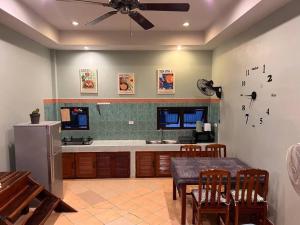 a kitchen with a dining table and a ceiling fan at Dreamcatcher Bungalow in Bophut