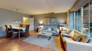 a living room with a couch and a table at Haus Sansibär in Wenningstedt