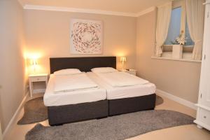 En eller flere senge i et værelse på Residenz Üüs Ailön