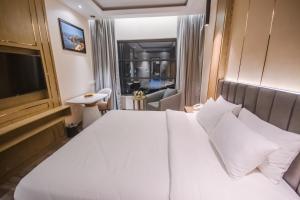 Postel nebo postele na pokoji v ubytování Frankincense Hotel Muscat فندق اللبان مسقط