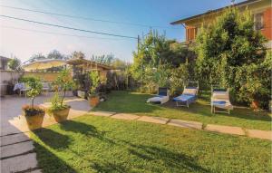 a yard with two chairs and a house at Awesome Home In Montignoso -Ms- in Montignoso +11 photos