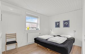 a bedroom with a bed and a chair in it at Nice Apartment In Bindslev With Wifi in Bindslev