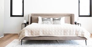 a bedroom with a large bed with two pillows at Hiiragi by H2 Life in Niseko