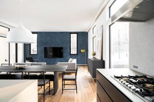 a kitchen and living room with a table and a dining room at Hiiragi by H2 Life in Niseko