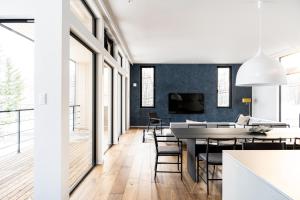 a dining room and living room with a table and chairs at Hiiragi by H2 Life in Niseko
