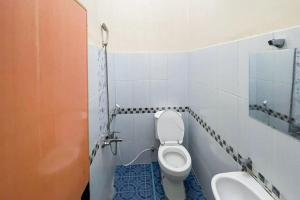 a bathroom with a toilet and a sink at Hotel Harapan Isyes Syariah RedPartner in Parapat +19 photos