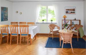 a dining room with a table and chairs at Nice Home In Urshult With Wifi in Urshult