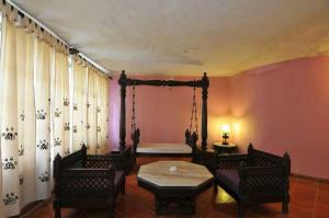 a room with a bed and a table and chairs at The Celebration Van Vilas in Kānha