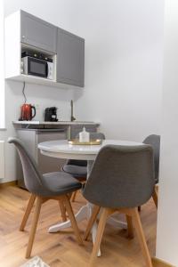 a kitchen with a table and chairs in a room at Poema in Oradea