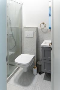 a white bathroom with a toilet and a shower at Poema in Oradea +42 photos