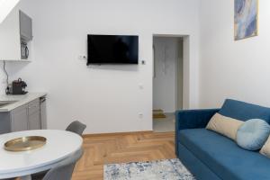 a living room with a blue couch and a table at Poema in Oradea