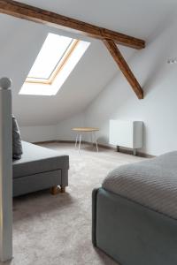 a bedroom with a bed and a couch and a window at Poema in Oradea