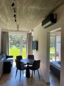 a living room with a table and chairs at Monciskes Apartment Seaside in Palanga