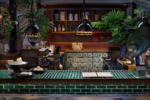 a shop with a counter with plants on it at Peking Yard Siheyuan Boutique Hotel &Garden&Terrace&Lama Temple&hutong&Houhai&Tiananmen&Bistro in Beijing