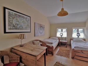 a living room with a bed and a table at Landhaus Westerweg - Familie Petersen in Wanderup