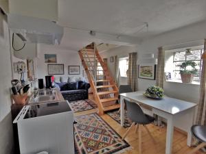 a kitchen and living room with a spiral staircase at Landhaus Westerweg - Familie Petersen in Wanderup