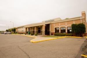 a large building with a sign on the side of it at Days Inn by Wyndham Minot in Minot