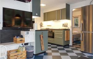 Vester SømarkenにあるNice Home In Aakirkeby With 2 Bedroomsのチェッカーフロアのキッチン(緑のキャビネット付)