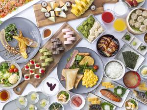 a table topped with plates of food and bowls of food at Richmond Hotel Nagoya Nayabashi in Nagoya