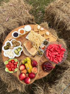 a table with a bunch of different types of food at Lake shkodra in Omarë