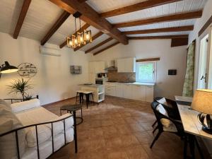 a living room with a table and chairs and a kitchen at Luna&Limoni Country in Muravera