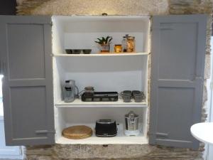 a pantry with two doors and a shelf with items at Apartamento foroplaza campo I in Lugo +25 photos