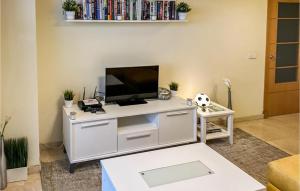 a living room with a tv on a white desk at Nice Apartment In Benalmádena Costa in Benalmádena