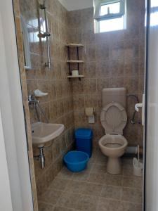 a bathroom with a toilet and a sink at Къща за гости Янка in Nesebar +51 photos