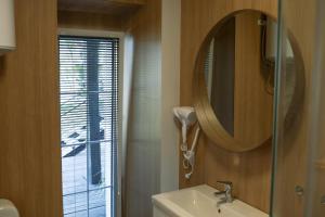 a bathroom with a mirror and a sink at Svedresort in Švedriškė +32 photos