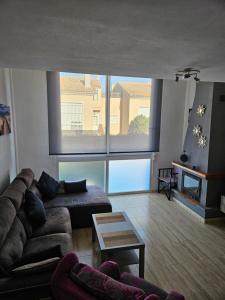 a living room with a couch and a large window at Los Belones, Mar Menor España in Los Belones