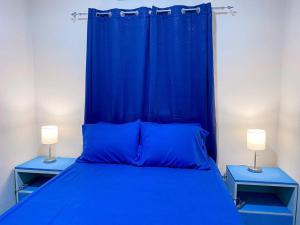 un letto blu con due comodini blu accanto di Blue Casita en Tela a Tela