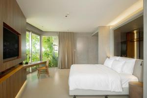 Ένα ή περισσότερα κρεβάτια σε δωμάτιο στο M Hotel Danang