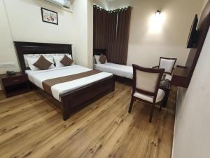 Voodi või voodid majutusasutuse SAK Royal Residency 2 kms from Mysore Palace toas
