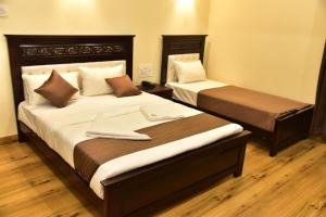 Voodi või voodid majutusasutuse SAK Royal Residency 2 kms from Mysore Palace toas