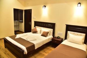 Voodi või voodid majutusasutuse SAK Royal Residency 2 kms from Mysore Palace toas