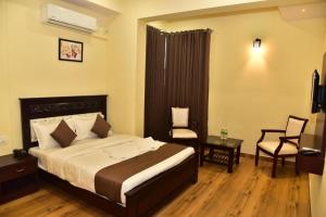 Voodi või voodid majutusasutuse SAK Royal Residency 2 kms from Mysore Palace toas