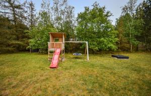 a playground in a field with a play equipment at Holiday Home Piledybet Humble Xi in Humble
