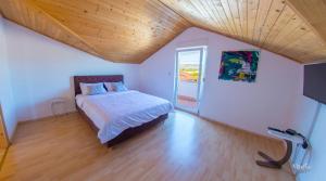 a bedroom with a bed and a wooden ceiling at Villa Pearl- with private pool in Blagaj