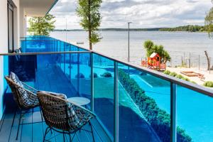 a balcony with a view of the water at BOSZKOWO Apartament "EDEL" 106 Aquarius in Boszkowo-Letnisko