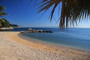 a view of a beach with rocks in the water at Apartment Džoni in Split
