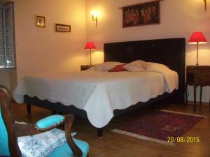 a bedroom with a bed with two babies sleeping on it at Holiday home Gîte des Hautes Côtes de Beaune in Magny-lès-Villers